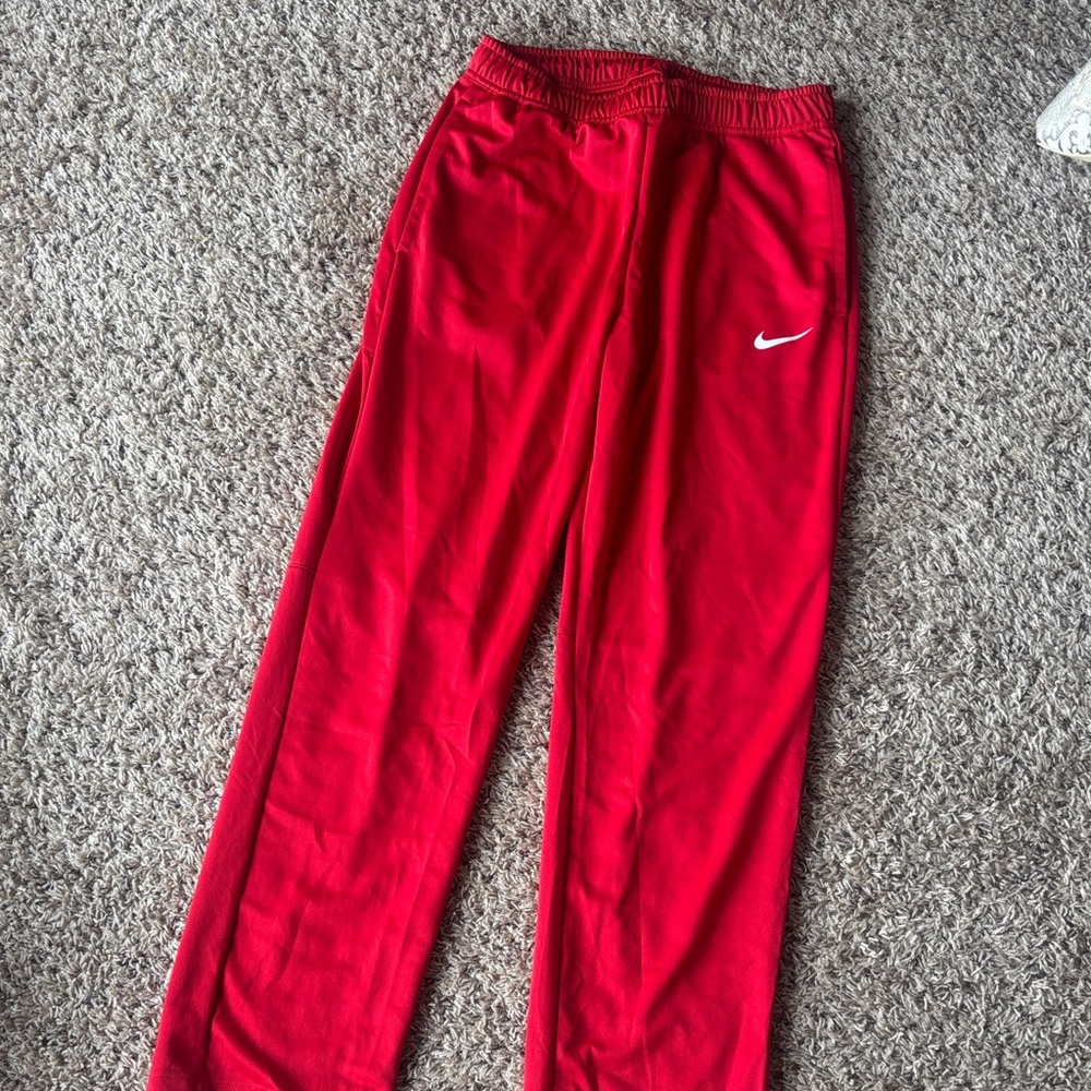 Men’s red Nike basketball warmup pants, size medium